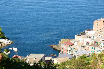 High angle view of buildings by sea