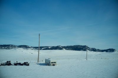 Scenic view of ski lift against blue sky