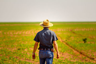 Rear view of man standing in field