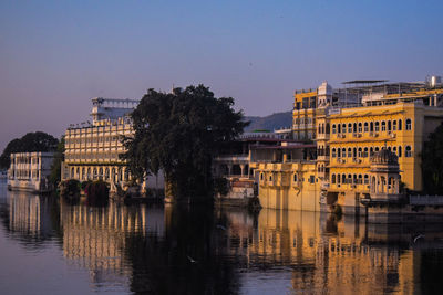 Reflection of buildings in city at waterfront