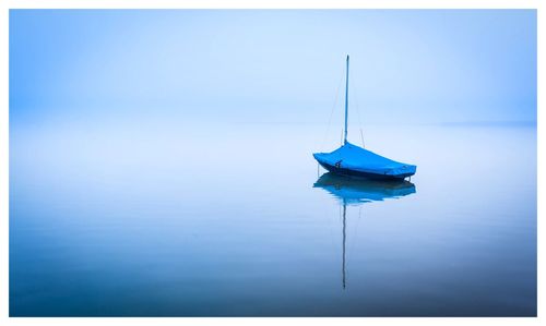 Sailboat moored in sea