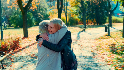 Couple kissing in park during autumn