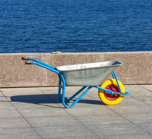Manual wheelbarrow on the sea promenade