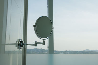 Close-up of coin-operated binoculars against sky