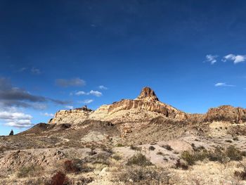 Rock formations on landscape against sky