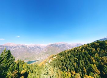 Scenic view of mountains against clear blue sky