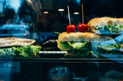 Close-up of sandwiches served on glass table