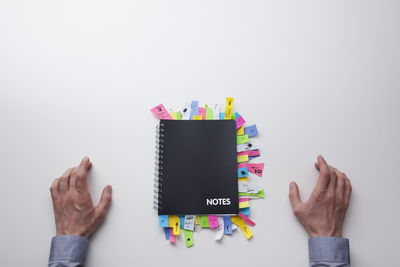 Midsection of person holding text against white background