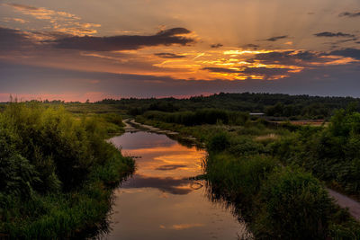 Scenic view of basingstoke canal landscape against sky during sunset