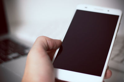 Close-up of hand holding mobile phone