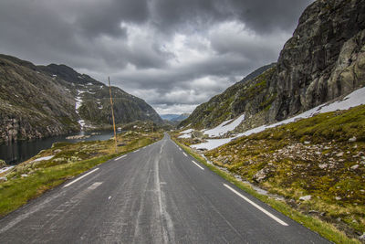 Road amidst mountains against sky