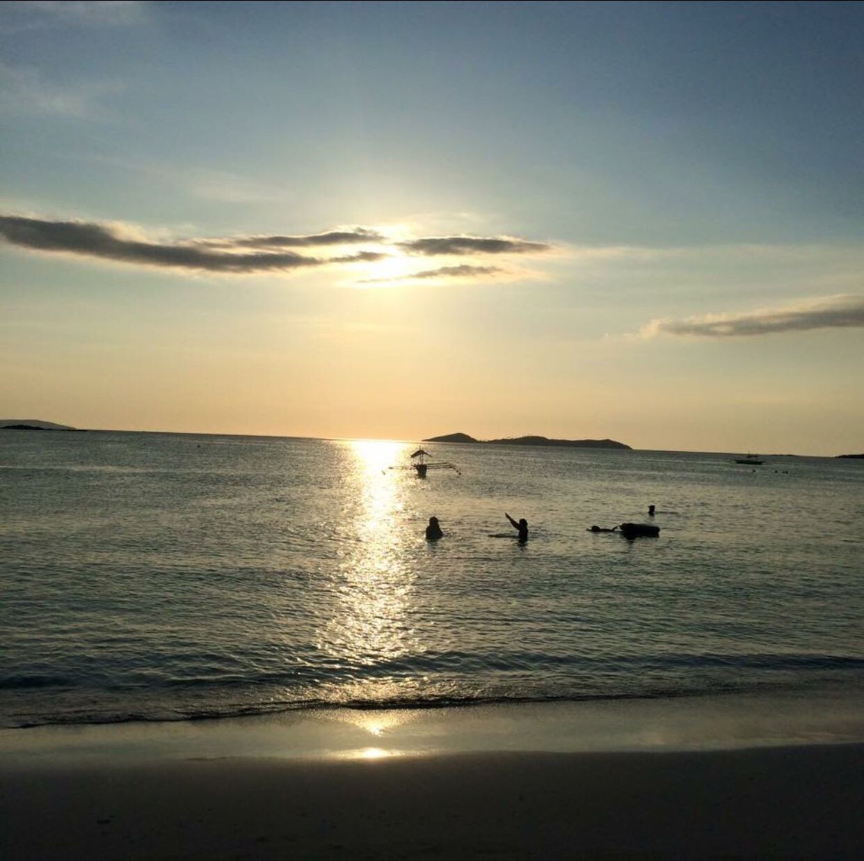 SILHOUETTE SWANS SWIMMING IN SEA AGAINST SKY DURING SUNSET