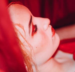 Close-up portrait of woman lying down