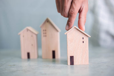 Close-up of hand holding paper house