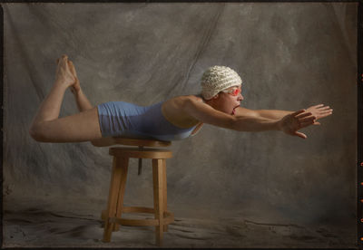 Side view of young woman sitting on seat