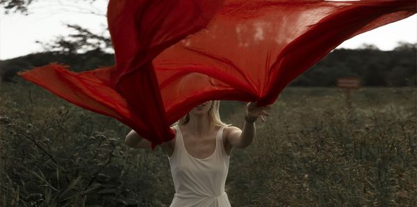 Midsection of woman standing on field