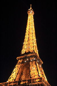 Low angle view of illuminated tower at night