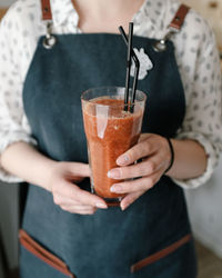 Midsection of woman holding drink