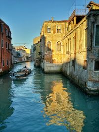 Canal along buildings in city