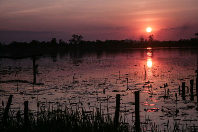 Scenic view of lake against orange sky