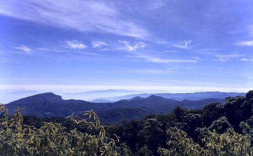 Scenic view of mountains against blue sky