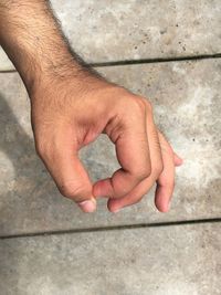 Close-up of hands against wall