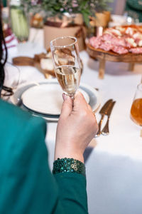 Cropped hand of woman holding wineglass