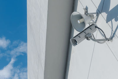 Low angle view of electric lamp against sky