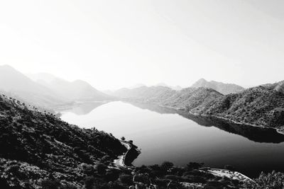 Scenic view of lake and mountains against clear sky