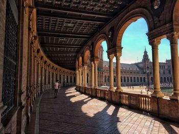 People walking in corridor of historic building