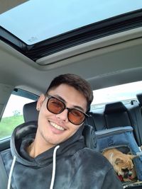Portrait of smiling young man in car