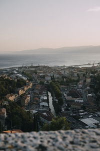 Aerial view of buildings in city against clear sky