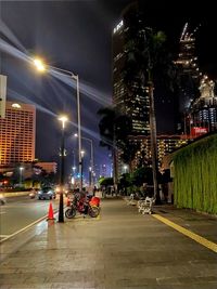 Illuminated city street and buildings at night