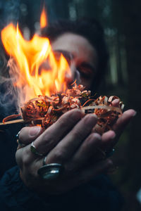 Cropped hand of person holding fire