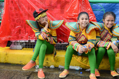 Full length portrait of smiling young woman dancing