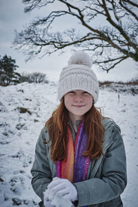 Portrait of smiling woman in snow field