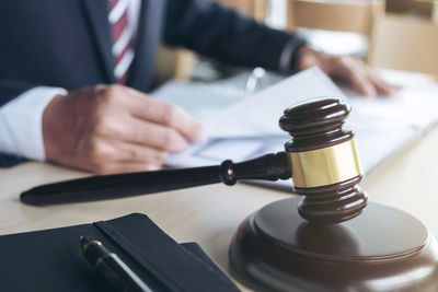 Midsection of lawyer working at desk in office