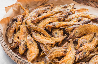 Close-up of dry fish in basket for sale