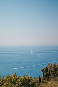 Scenic view of sea against clear blue sky