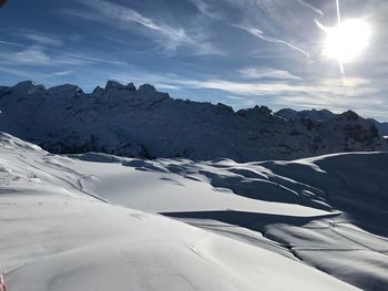 Scenic view of snow mountains against sky