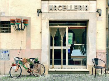 Bicycle on sidewalk against building