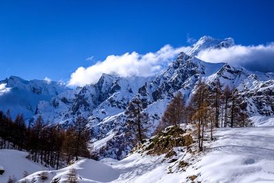 Scenic view of snow covered mountains against sky