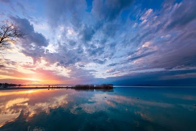 Scenic view of a lake against sky during sunset