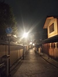 Illuminated street light against sky at night