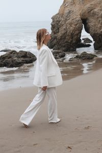 Rear view of woman standing at beach