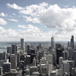 Skyscrapers against cloudy sky