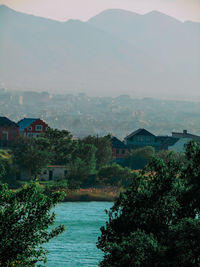 Scenic view of buildings and mountains against sky