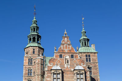 Low angle view of historic building against clear blue sky