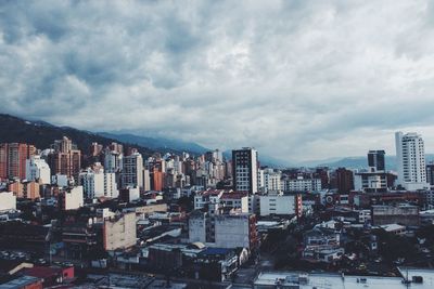 Buildings against cloudy sky