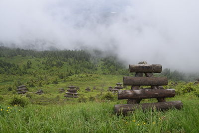 Hay bales on field against sky